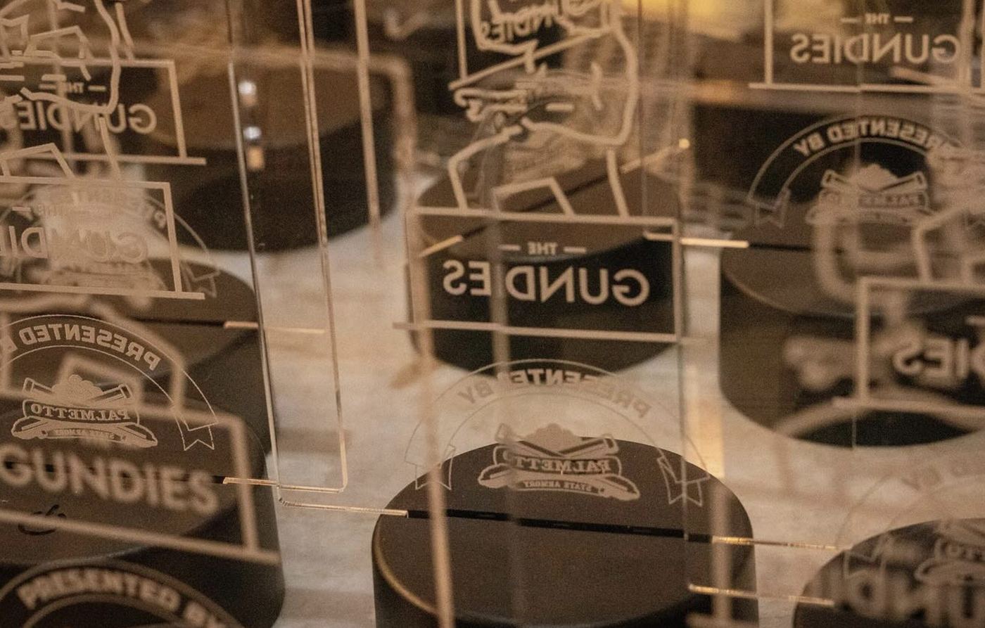 Laser-etched acrylic Gundies awards with sponsor co-branding